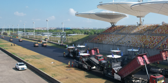 A large white stadium with a few vehicles on it

AI-generated content may be incorrect.